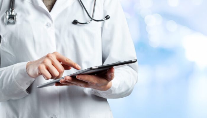 Doctor using digital tablet
